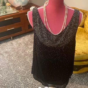 Ecru beaded black top.